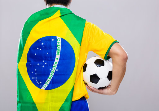 Man with Brazil flag and hold soccer ball