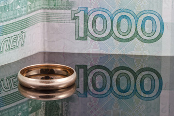 Golden wedding ring and thousand rubles