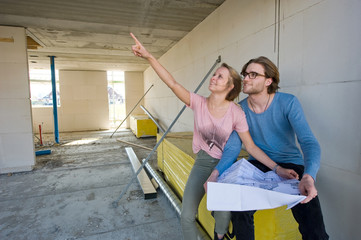 Fototapeta na wymiar Young couple on construction site