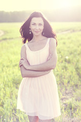 Fototapeta na wymiar Beautiful woman in pink dress standing outdoors