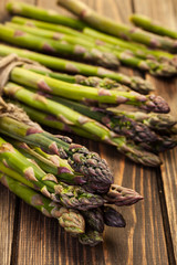 Bunch of young asparagus on wooden table