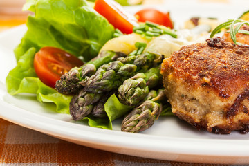 Meatballs served with boiled potatoes and asparagus