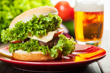 Cheeseburger on a plate with beer