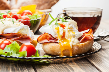 Eggs Benedict on toasted muffins with ham