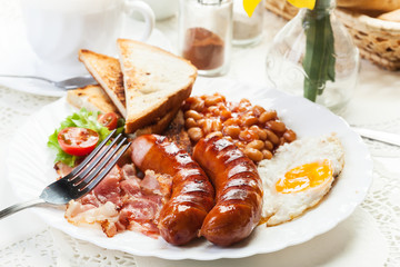 Full English breakfast with bacon, sausage, egg and baked beans
