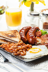 Full English breakfast with bacon, sausage, egg and baked beans