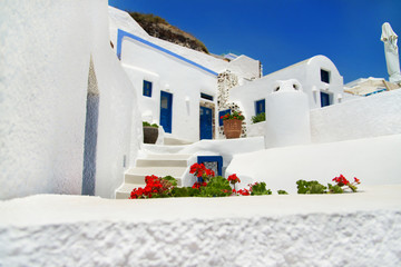 white - blue Santorini traditional architecture with flowers