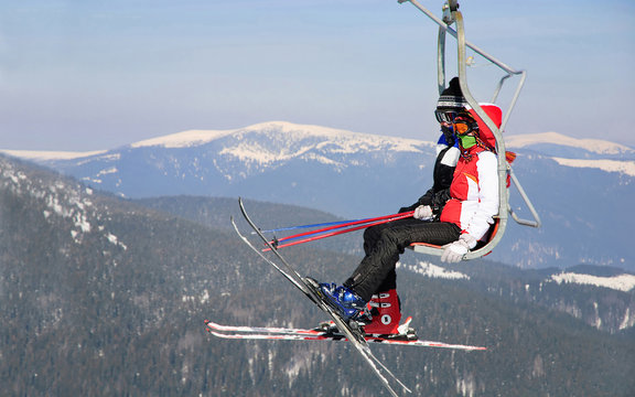 Skiers couple on a ski lift