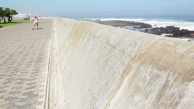 Fit man rollerblading by the coast