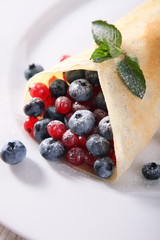 Pancakes with cream and fresh blueberries