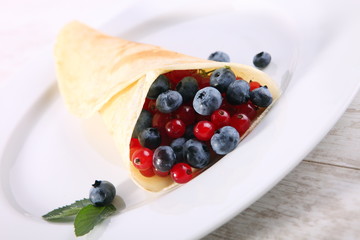 Pancakes with cream and fresh blueberries