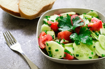 salad from cucumbers, tomato and green onions