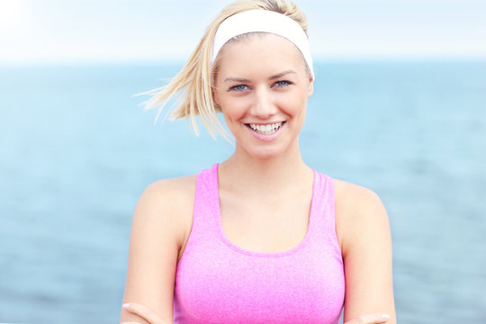 Beautiful Young Woman in Pink Sports Bra Running Stock Photo