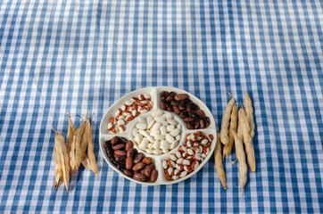 plate dried beans mix pod on checked tablecloth