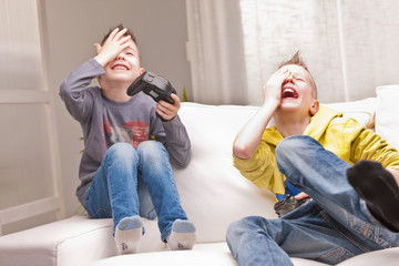 two kids playing video games © Giulio_Fornasar