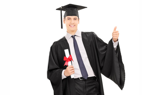 Male graduate holding diploma and giving thumb up