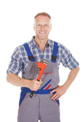 Smiling Handyman Holding Adjustable Wrench