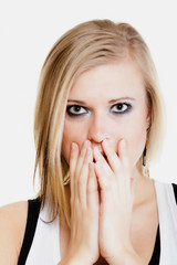 Surprised afraid girl covering mouth with hand