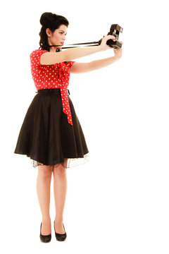 Retro. Pinup girl taking photo with vintage camera