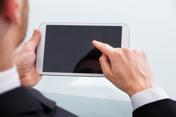 Businessman Holding Digital Tablet In Office