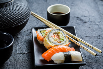 Closeup of fresh sushi served in with tea