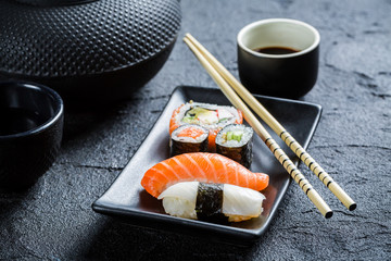 Closeup of fresh sushi served in a black ceramic