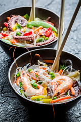 Seafood and vegetables served with noodles
