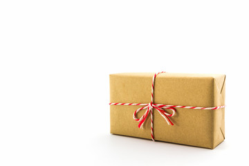 Cardboard carton wrapped with brown paper, tied with string.