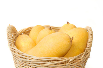 closeup ripe mangoes in basket