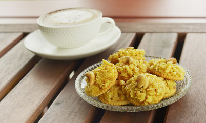 cracker topped corn flake and hot cappuccino coffee