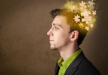 Young person thinking with glowing puzzle mind