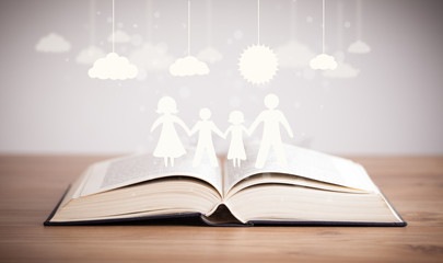 Cardboard figures of the family on opened book