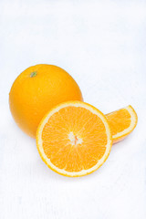 Ripe orange isolated on white wooden background