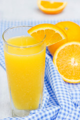 Glass of orange juice on wooden table