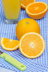 Oranges cut set and orange juice on table