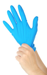 Doctor putting on protective gloves, isolated on white