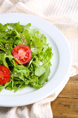 Green salad made with  arugula, tomatoes and sesame