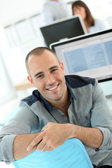 Portrait of student in front of desktop computer