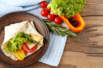 Veggie wrap filled with chicken and fresh vegetables
