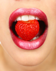 Strawberry in teeth, close up