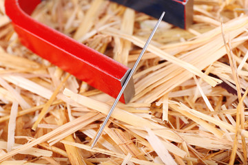 Magnet and needle on hay background