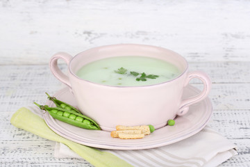 Tasty peas soup on wooden table