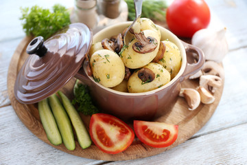 Young boiled potatoes in pan with vegetables
