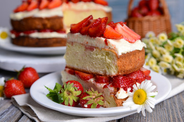 Delicious biscuit cake with strawberries on table close-up