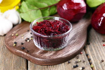 Grated beetroots in bowl on table close-up