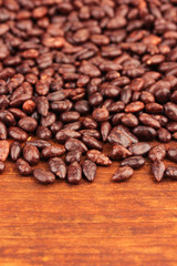 Sunflower grains in chocolate, on brown  wooden background