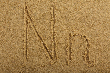 Alphabet letter written on wet beach sand