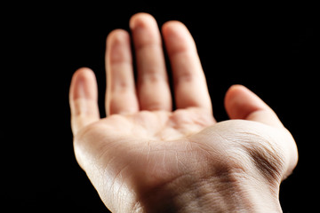 Human hand on black background