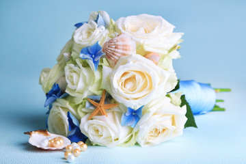 Beautiful wedding bouquet with roses on blue background