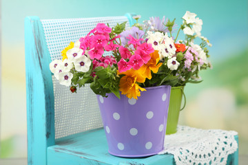 Bouquet of colorful flowers in decorative buckets,